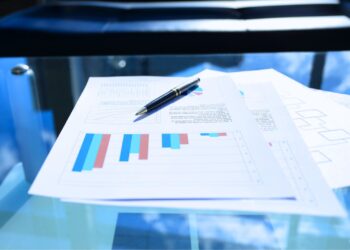 Gráficos financeiros e documentos sobre a taxa Selic acumulada, refletindo o impacto das variações na economia e nos investimentos.